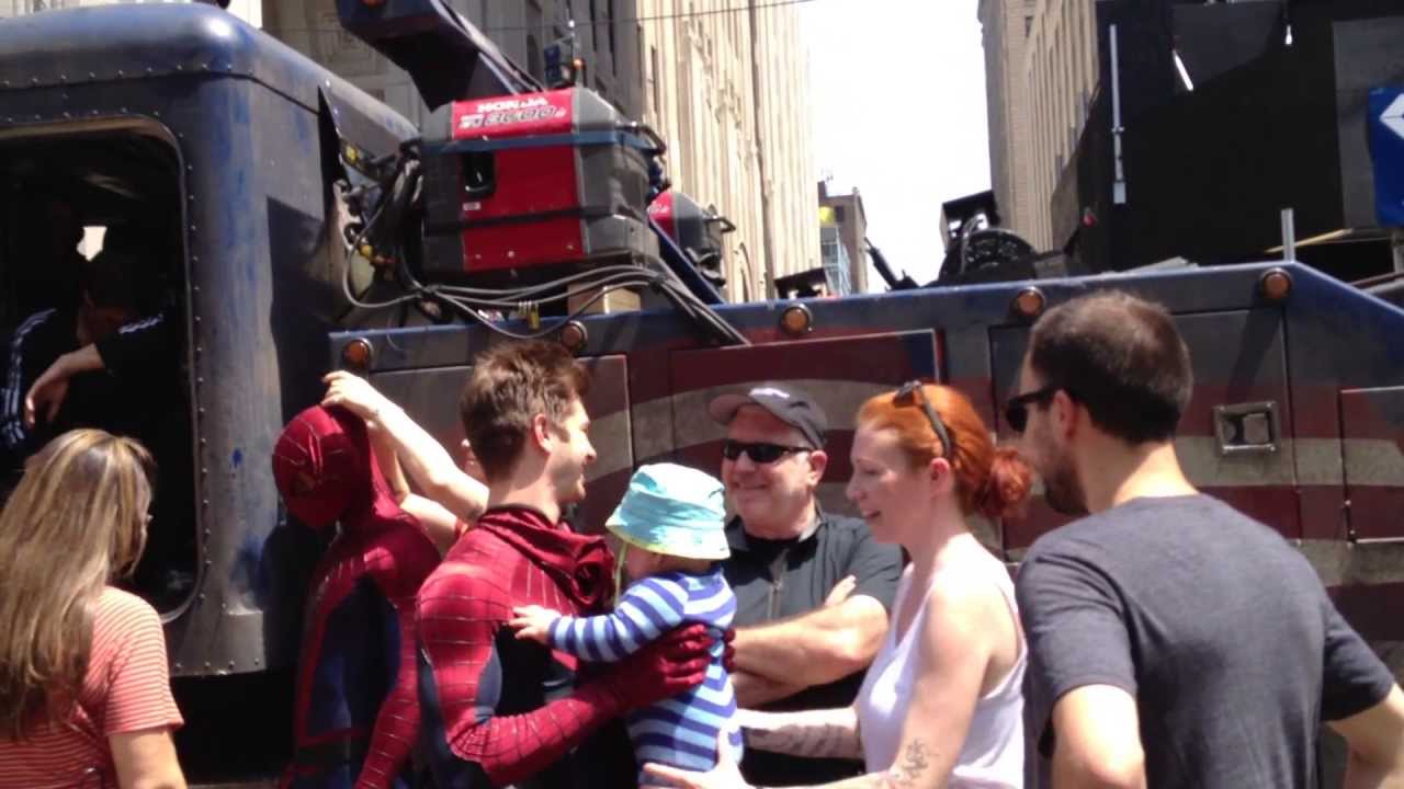 The Amazing Spider-Man, Andrew Garfield, greets a tiny fan while filming in NYC