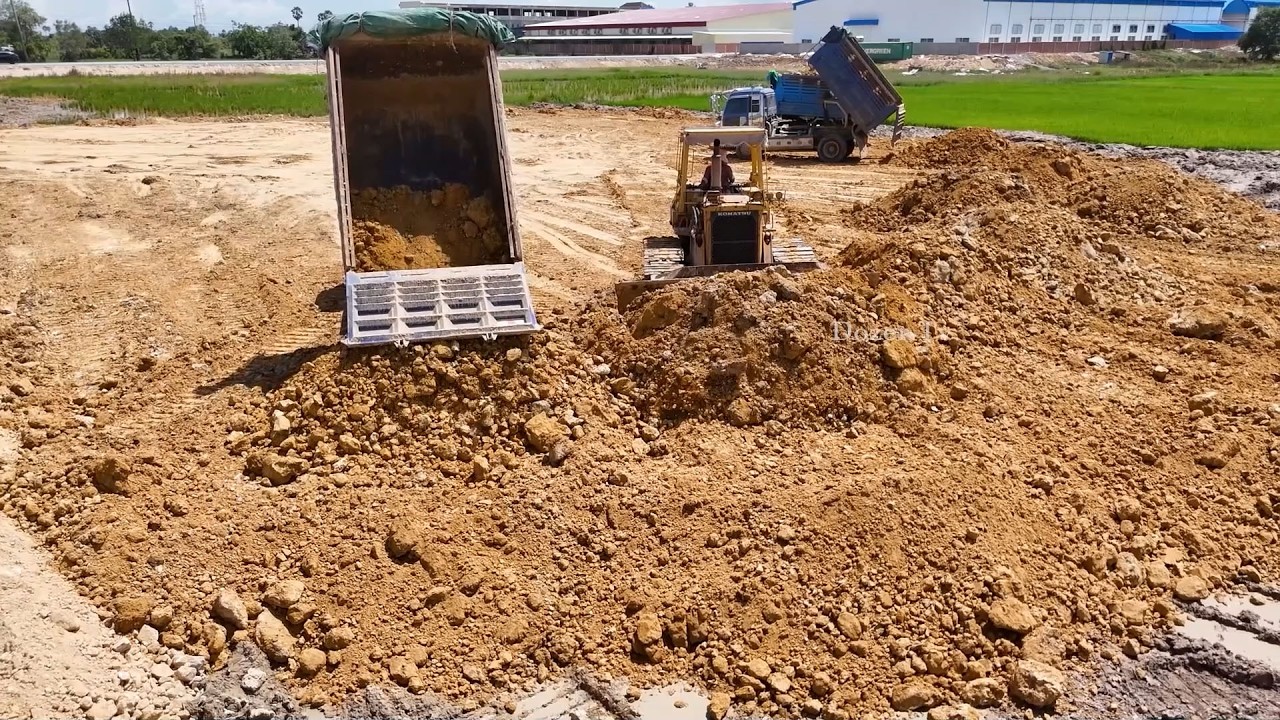 Good job! Land Filling Action D53P KOMATSU Bulldozer and Dump Trucks Working in Perfect Coordination