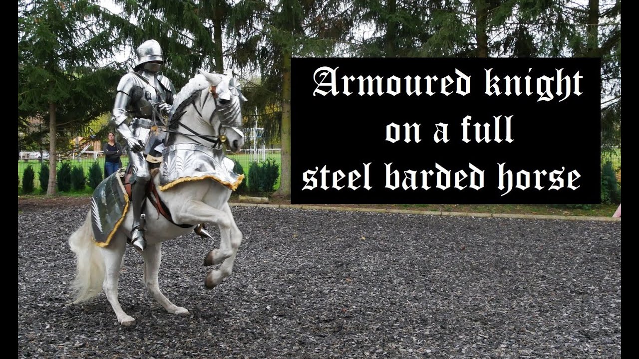 Riding in armour on a fully barded steed.