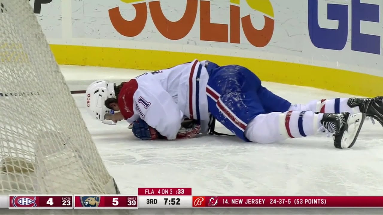 Jake Evans helped off the ice after crashing hard into the end boards
