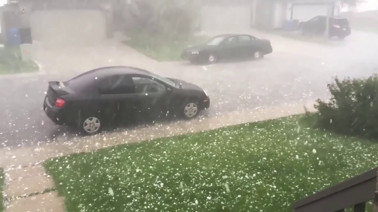Black car smashed by hail - advert for hail protection car cover
