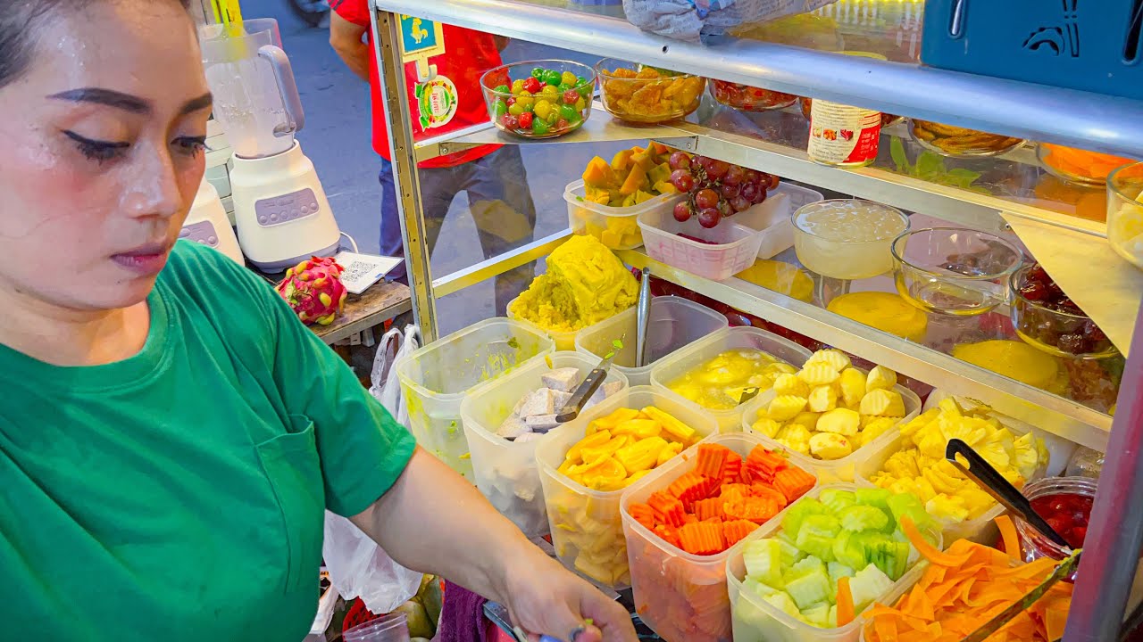 Beautiful lady selling Fruits Smoothies and dessert, Cambodia street food