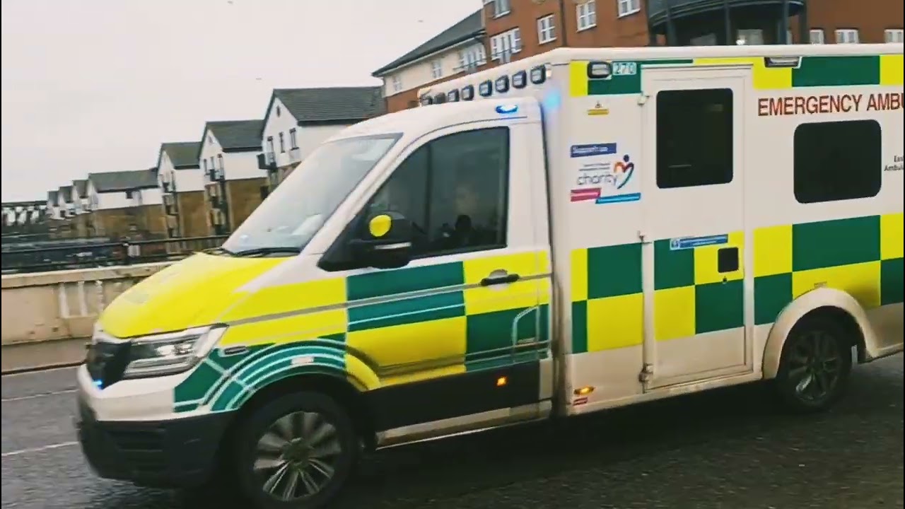 DK25 TUO - East of England MAN ambulance heading over Town Bridge on an emergency call 