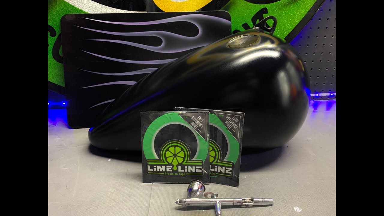 Laying out fineline tape and airbrushing marbleized texture flames on a Harley Davidson tank 