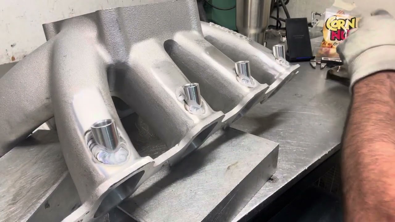 The EFI bungs are tacked in Rodney's new intake, time to weld them up!!