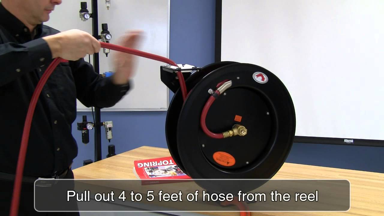 Spring tension adjustment on a hose reel with one arm
