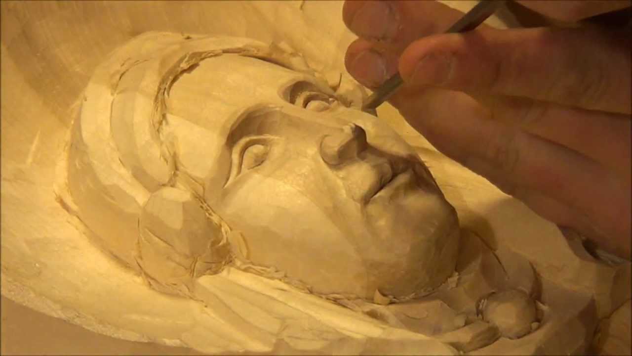 Carving a female face in wood