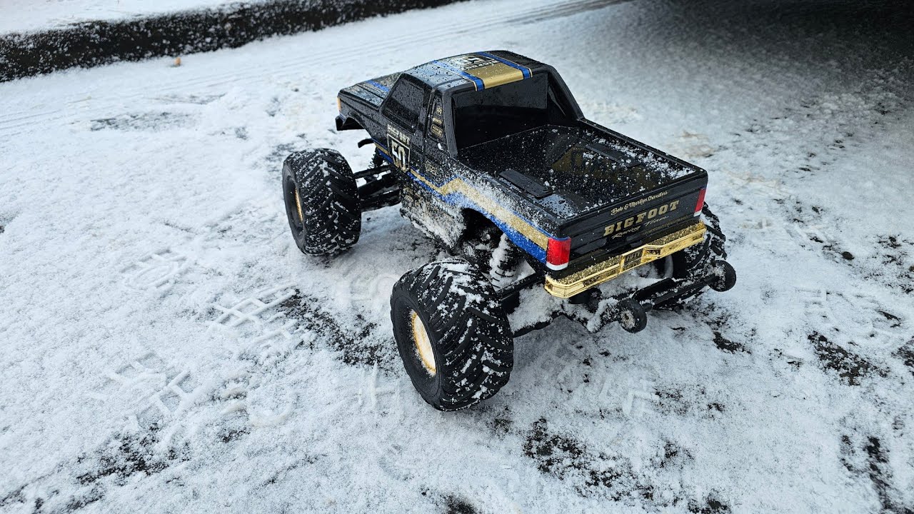 Traxxas bigfoot 50th anniversary eating the icy snow . 