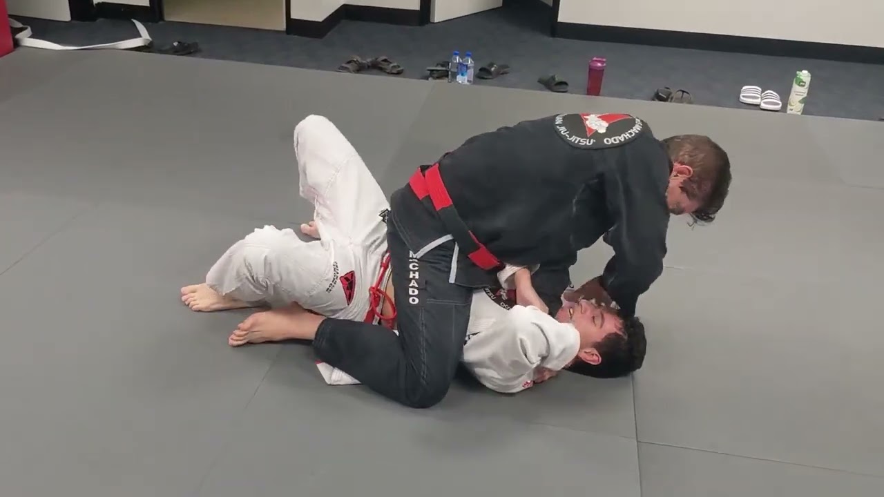 Jean Jacques Machado Rolling with White Belt Student