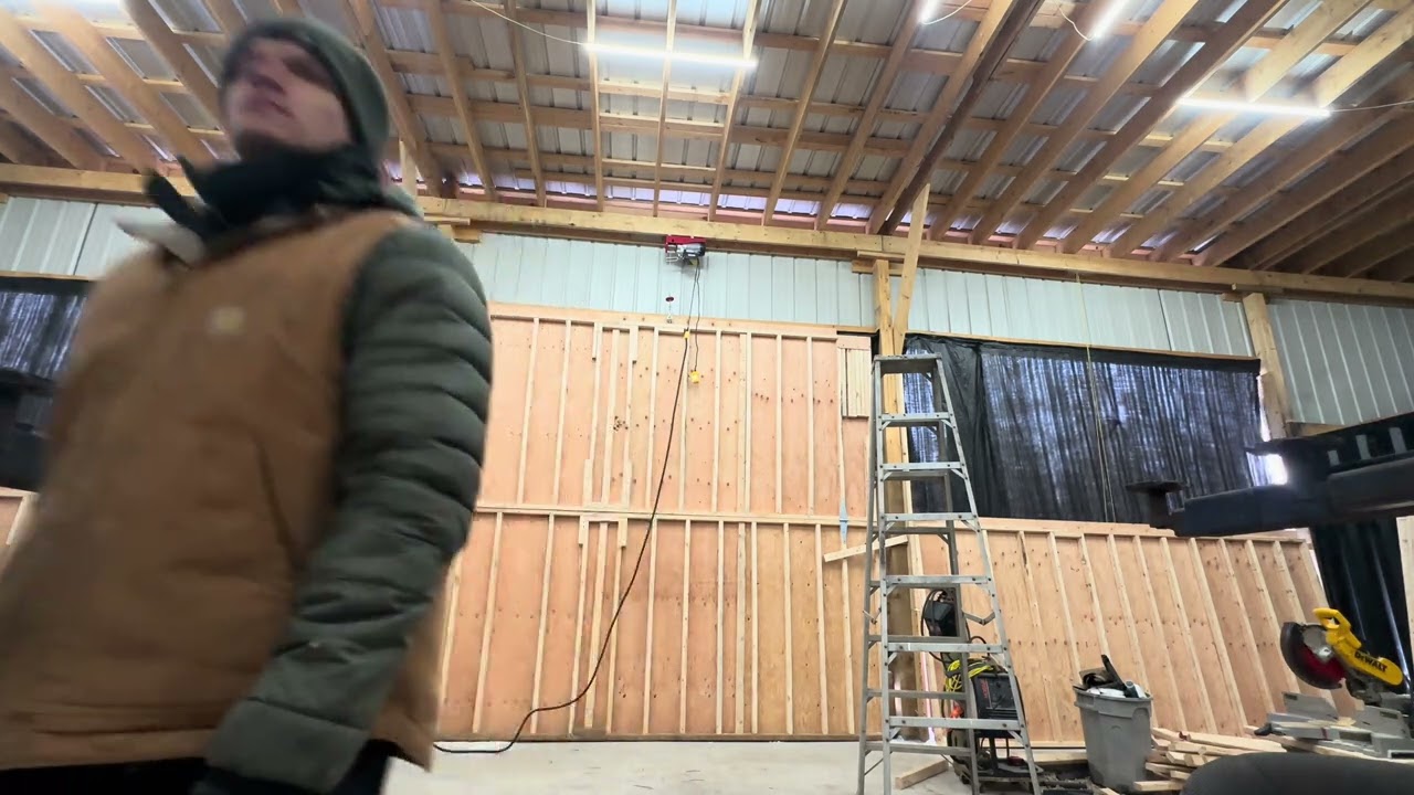 Installing upper garage door panel in shop 2 piece hanger style made of wood 