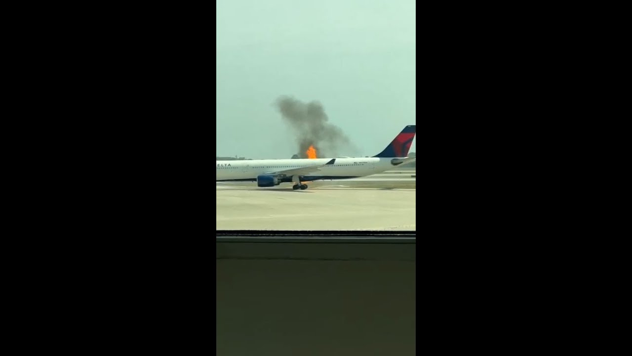 Passengers evacuate plane after engine bursts into flames