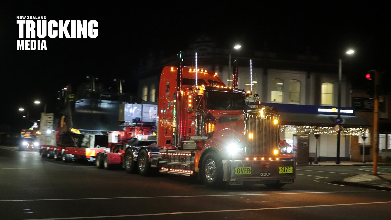 Heavy-haul Kenworth T909 moves by night