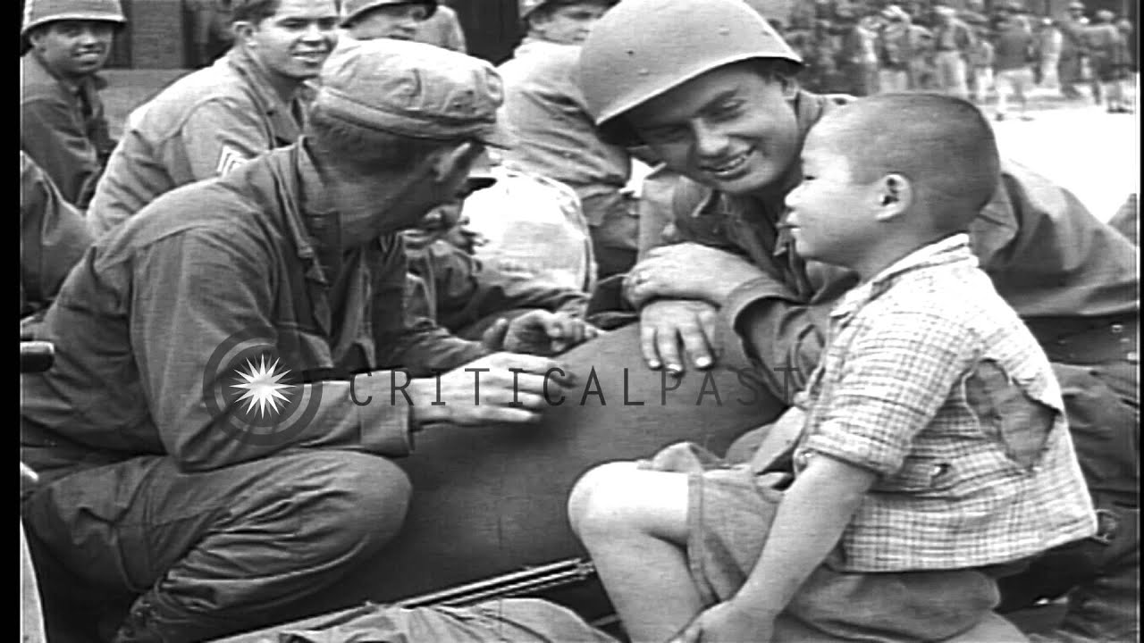 United States 32nd Division troops standing and sitting around Sasebo railroad st...HD Stock Footage