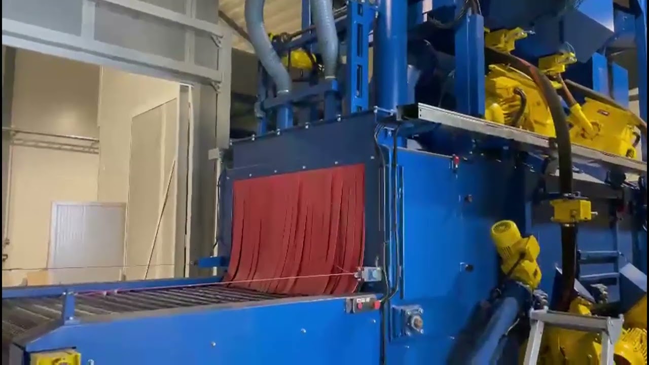 Shotblasting machine with lamellar conveyor and noise reduction chamber located in Scandinavia.