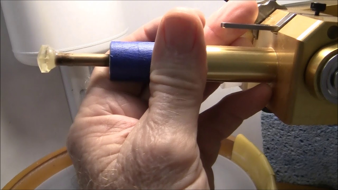 Gemstone faceting: cutting a cubic zirconia cushion cut.