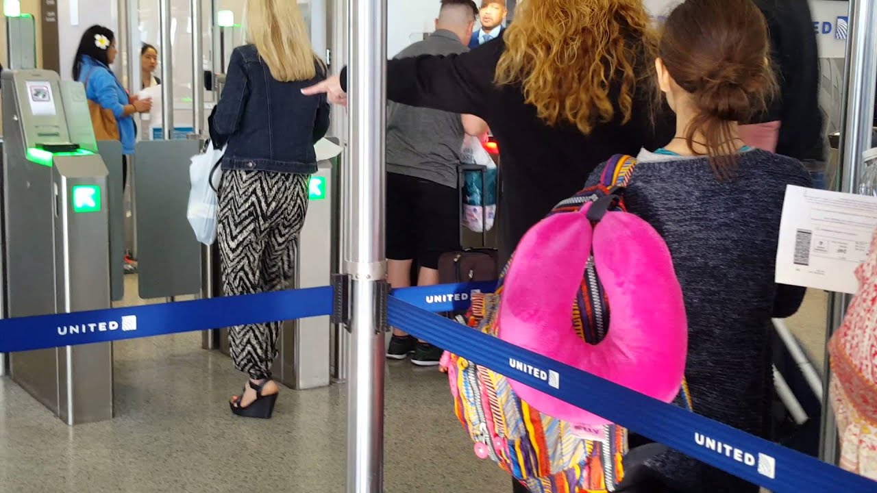 People trying to scan their own boarding passes