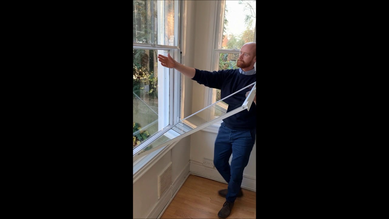 Tilt back vertical slider secondary glazing operation