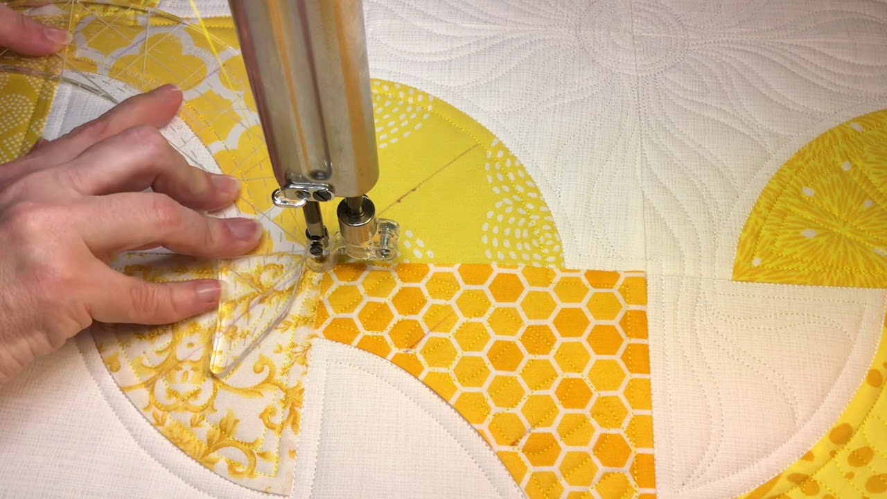 Quilting bird and sun motifs on Mod Journey quilt