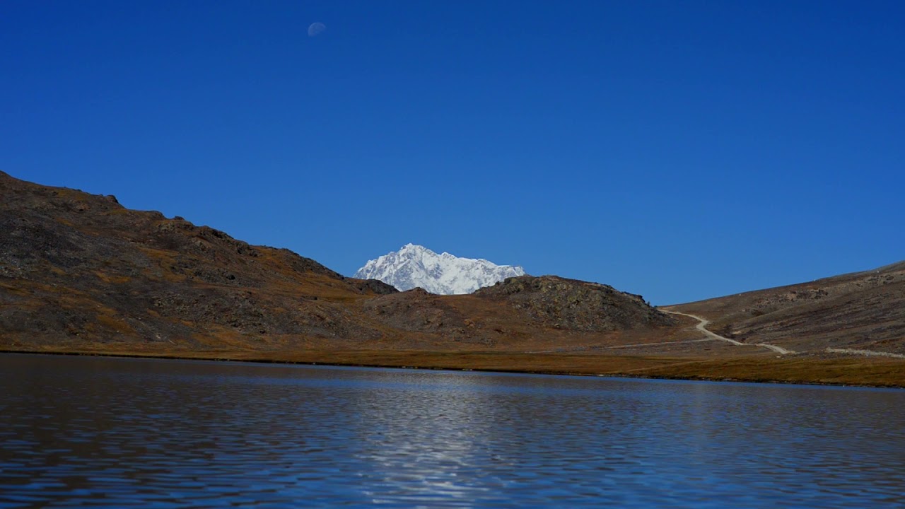 Nanga Parbat from Sheosar Lake under blue sky and a shy moon