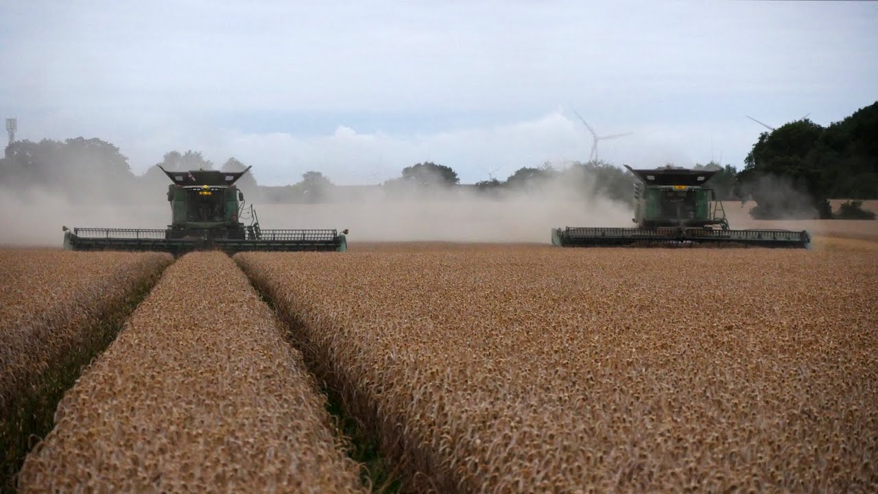 Two John Deere X9's with 40 foot headers and some big balers in action