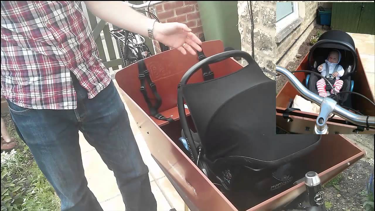 Carrying an infant in a Bakfiets using maxi cosi and rain tent