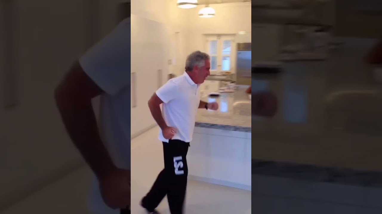 A newly released video shows Jeffrey Epstein moving around the kitchen island inside 