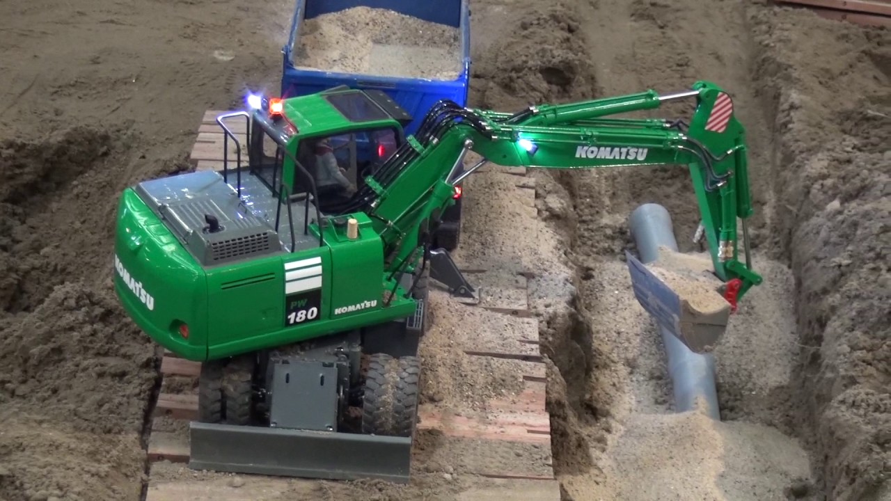 Komatsu PW180 working at a small construction site