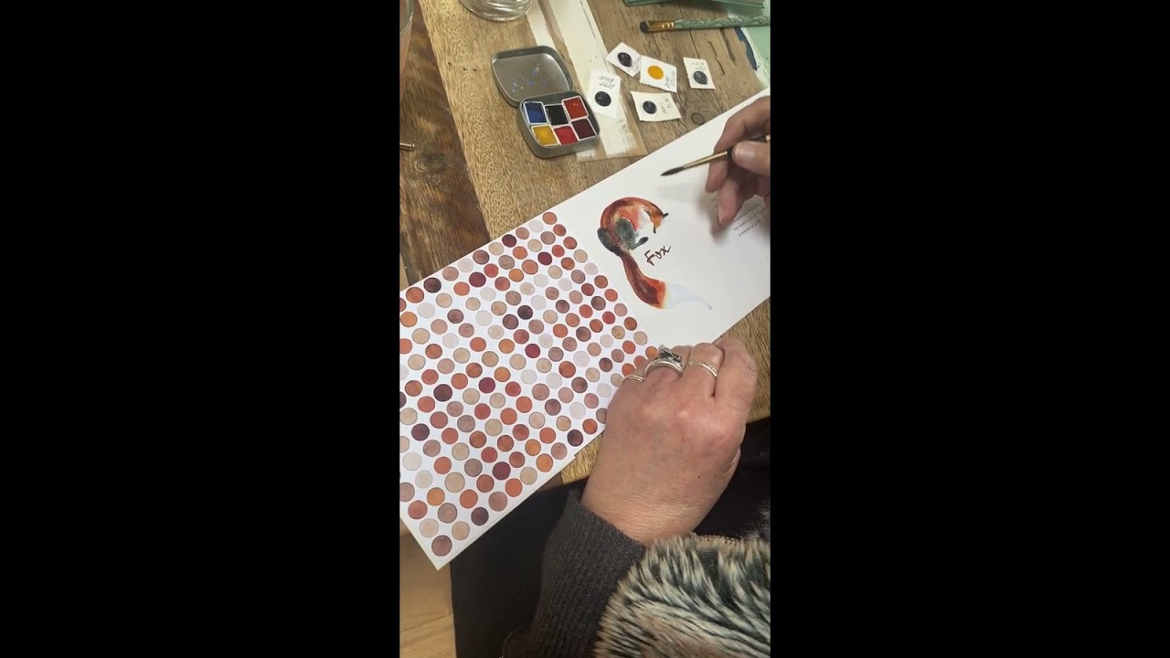 Jackie Morris hand-adorns a copy of her Fox Accordion book