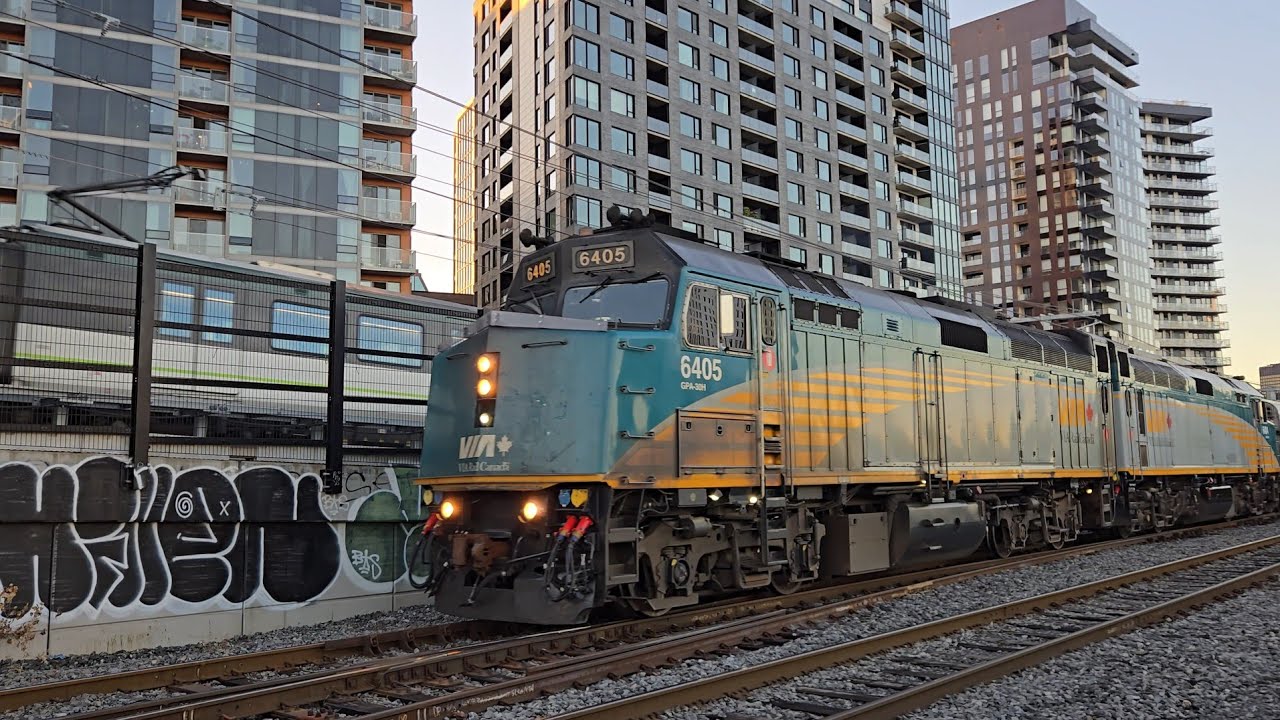 TRAINS Montreal REM and Via Rail Oceal Pass Close Up Through Griffentown 