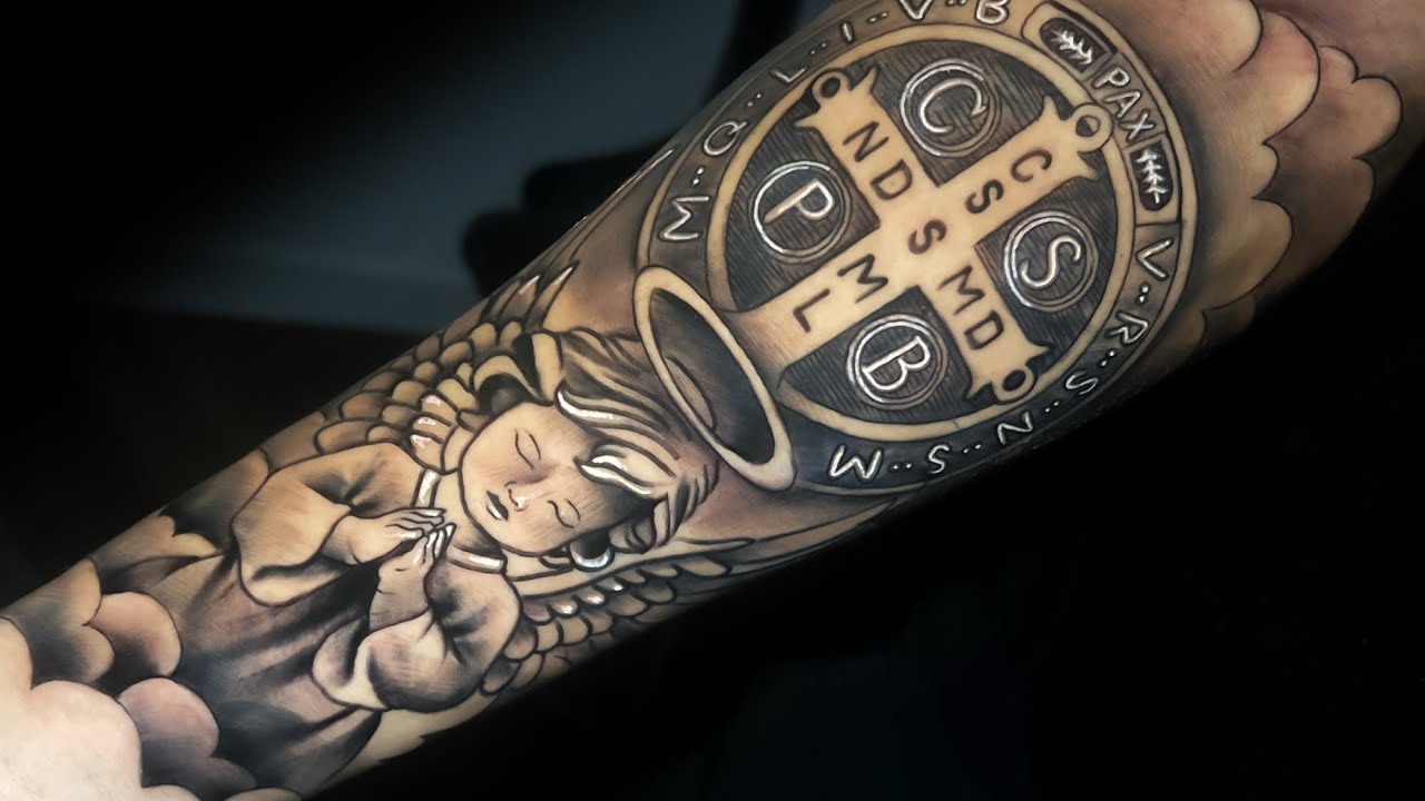 TATUAGEM DE MEDALHA DO SÃO BENTO COM ANJO