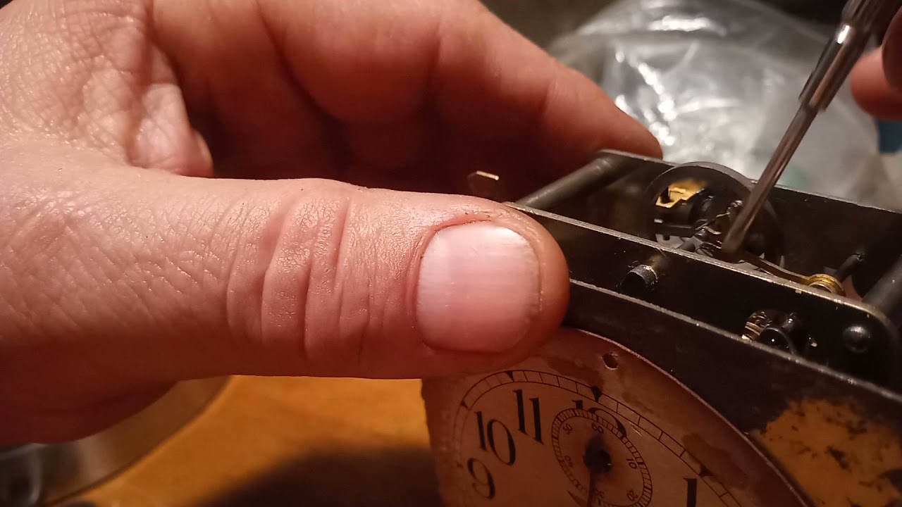 Adjusting a hair spring clock movement. Do not use the plyers to do this. Use screwdriver in notch.