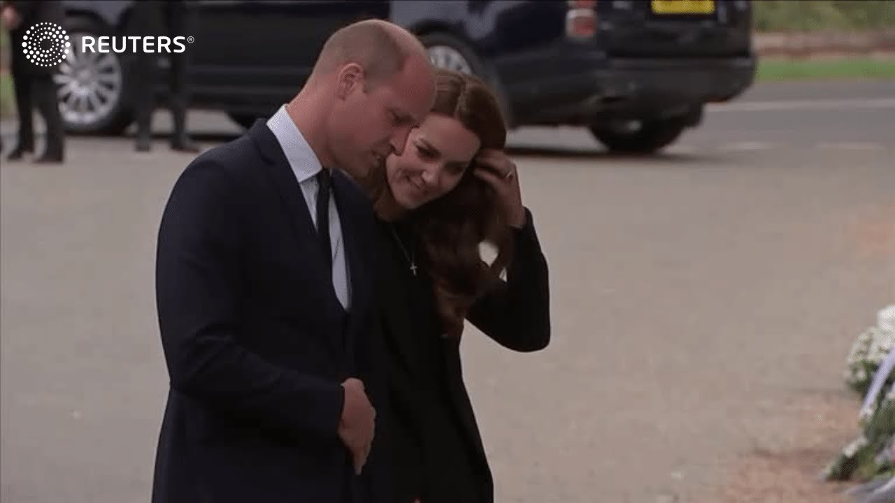 William and Kate view flowers outside Sandringham