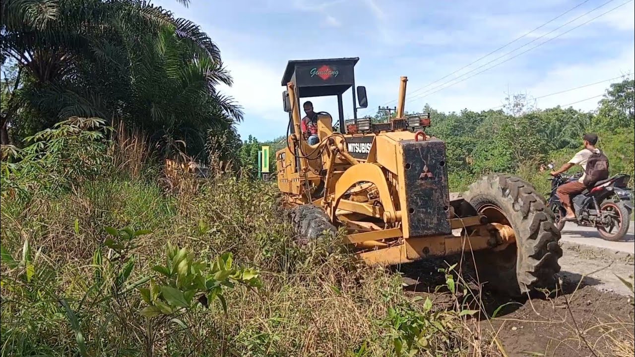 Motor Grader Clearing Scrub On The Road To Widen