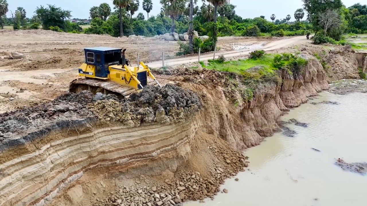 Innovative Landfill Up Deep Pond Process Bulldozer Clearing Soil & Dump Truck Moving Soil into Huge