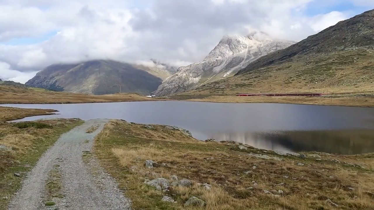 Hiking from Diavolezza to Alp Gr&uuml;m along lake Lago Bianco, Engadin, Switzerland