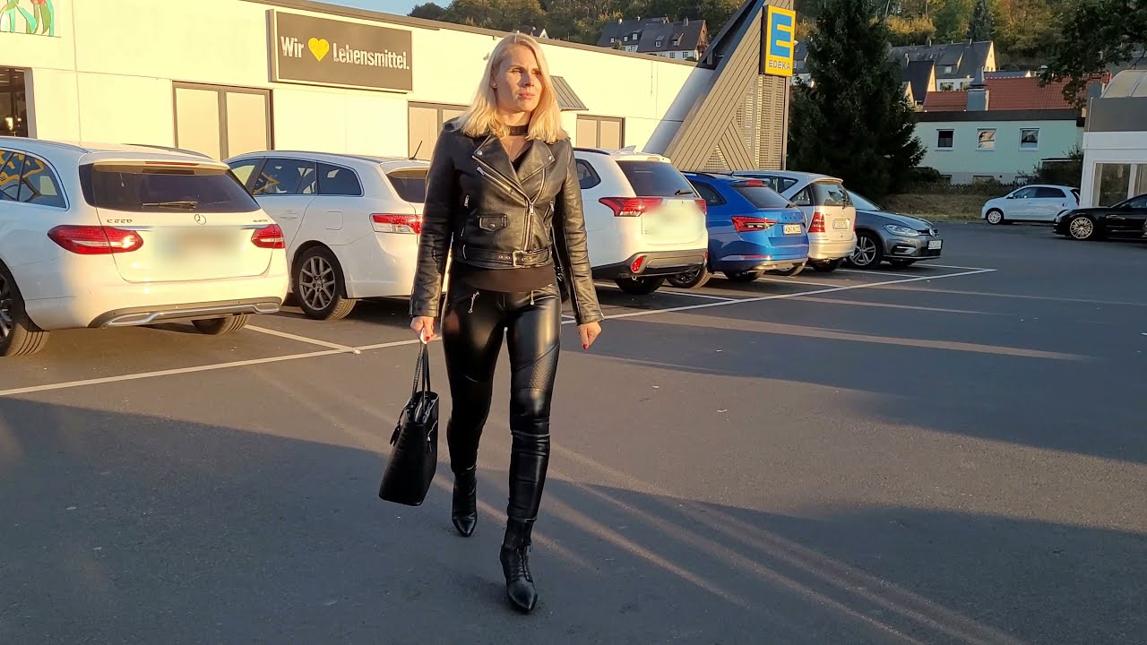 Caribig in black motorcycle leather leggings, leather jacket and high heels boots