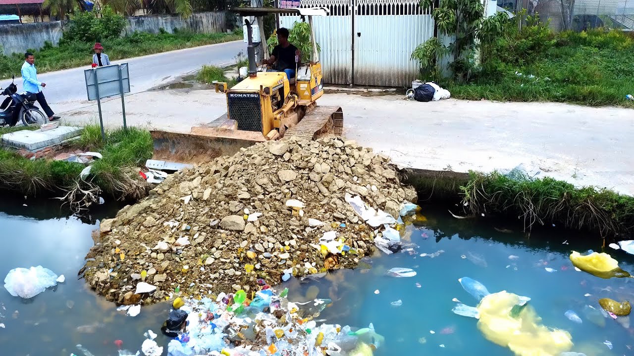 Rock pouring activities in deep water and shoreline areas using small-scale machinery