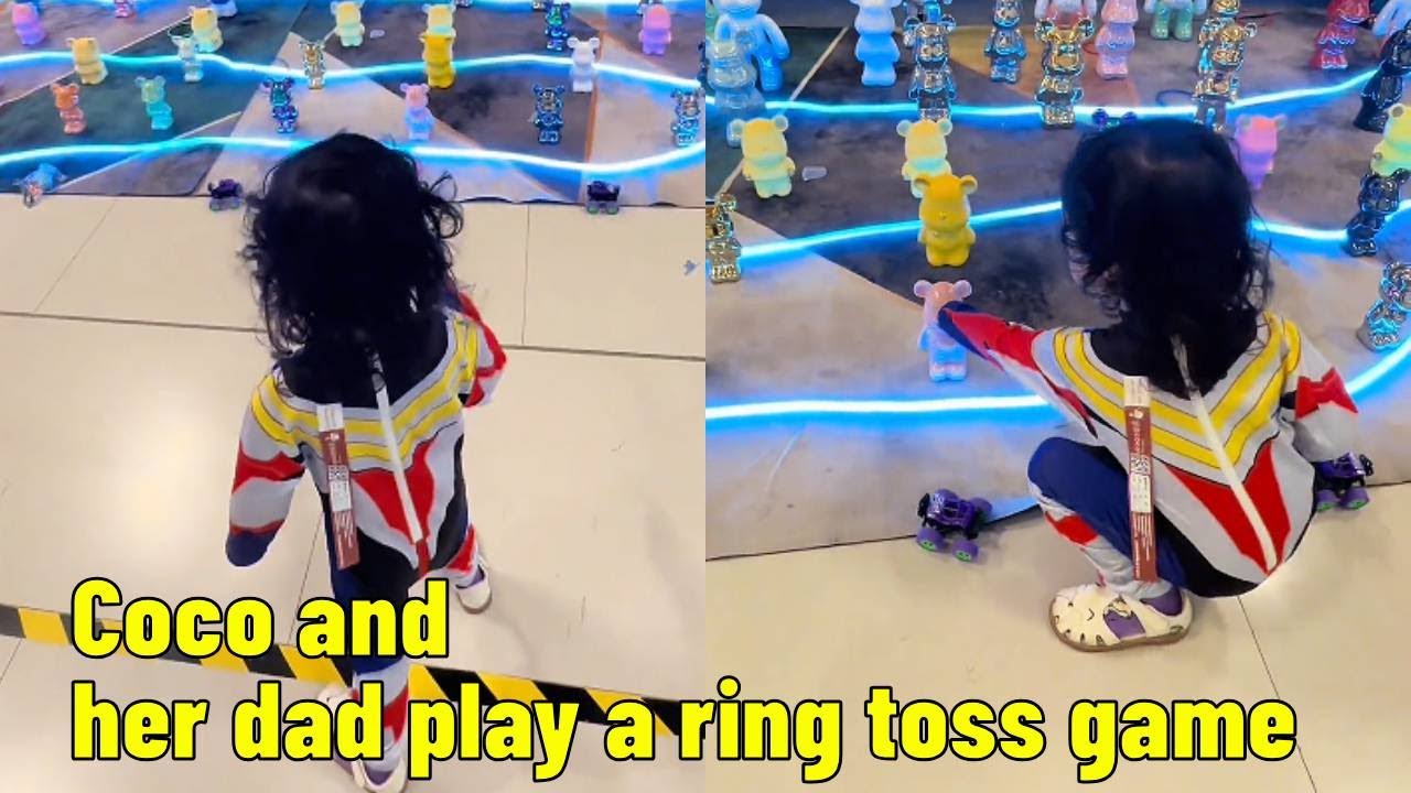 Coco and her dad play a ring toss game.【Parent-child Adventure CoCo】
