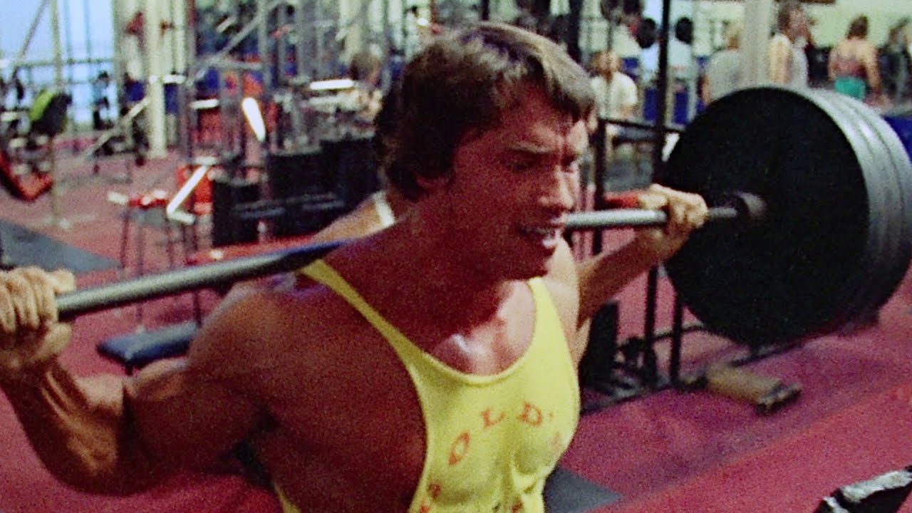 Arnold Schwarzenegger and Ed Corny train their legs by doing barbell squats/  Pumping Iron (1977)