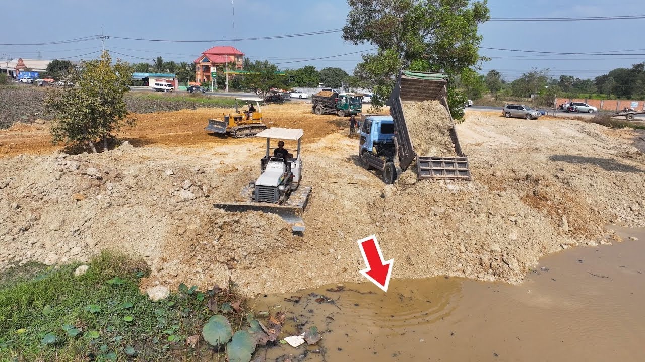 Incredible! Massive Dump Truck Unloading Soil as Twin Dozers Push Dirt Into Water