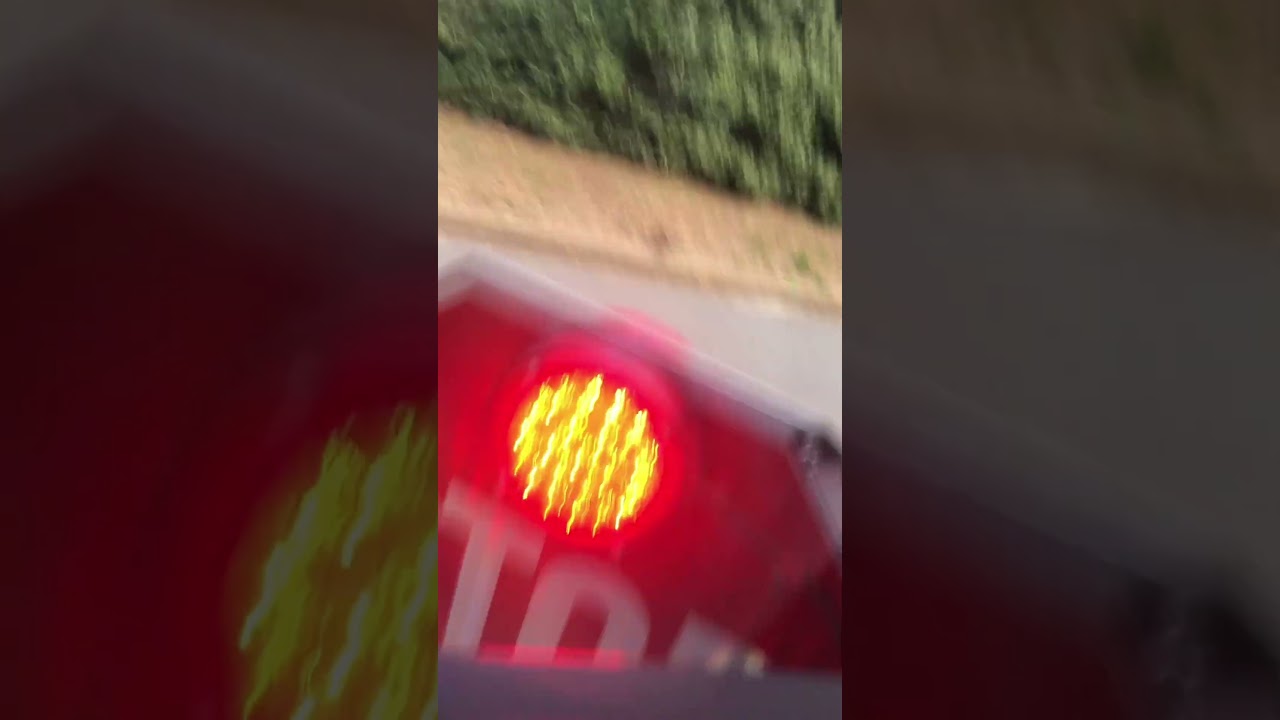 Bus driving down the street stop sign
