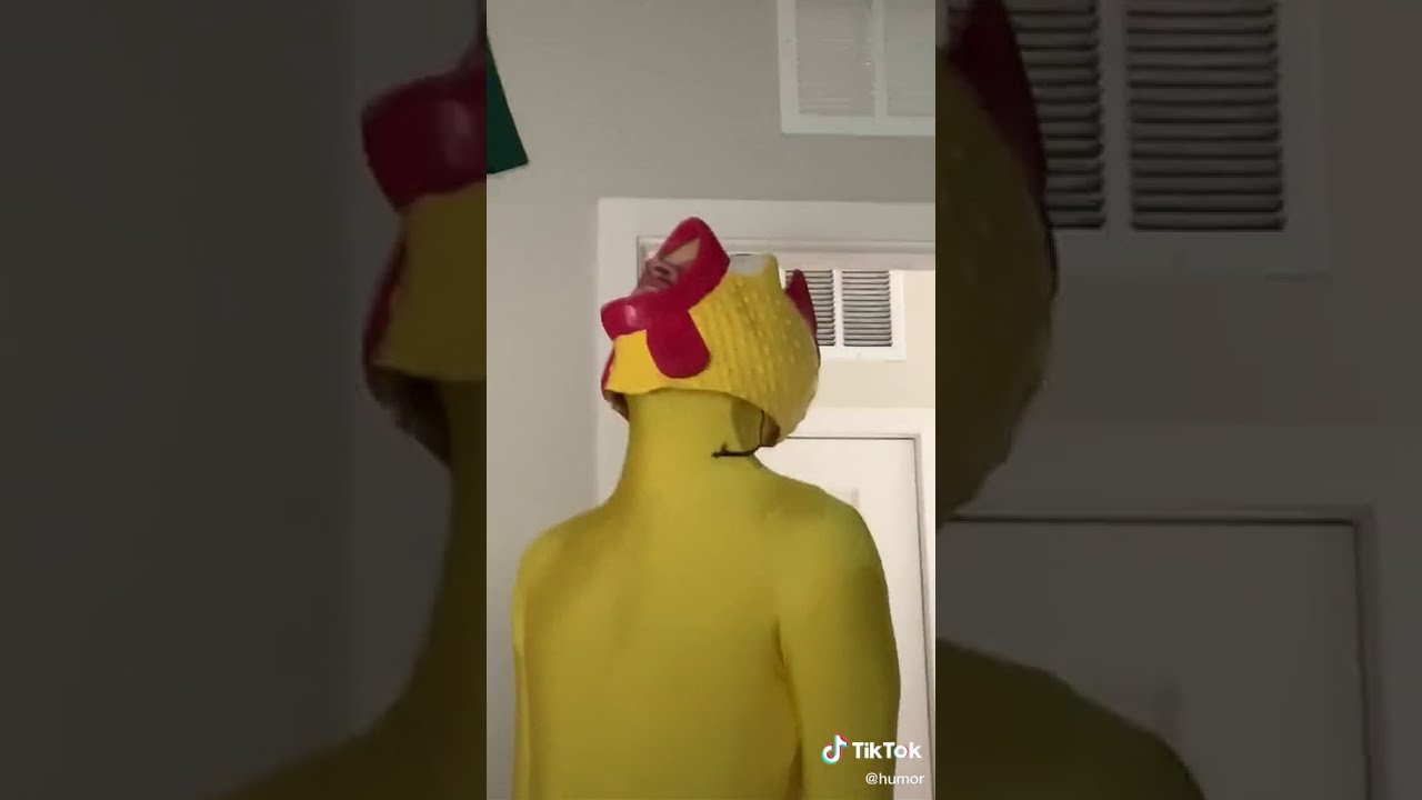 Man in rubber chicken suit
