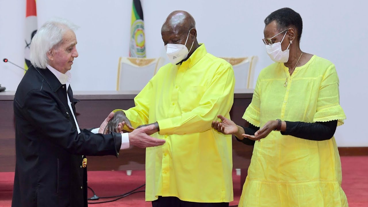 Prophecy: Benny Hinn holds Museveni's hands in powerful family prayer with his wife, Janet