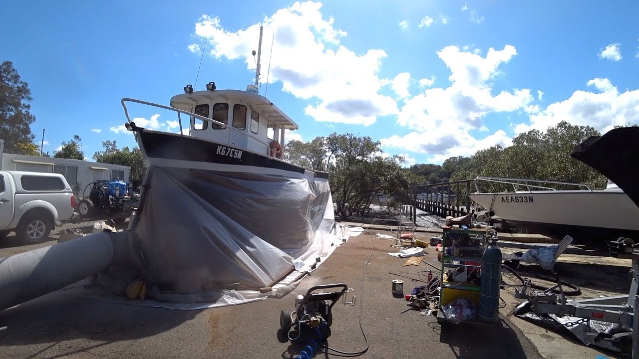 Sandblasting and priming the steel trawler hull