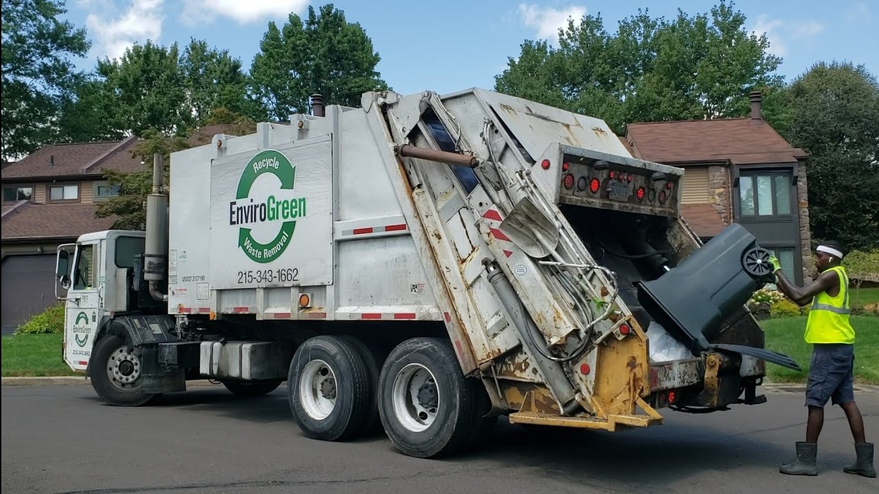 EnviroGreen CCC Pak-Mor rear loader garbage truck on heavy manual trash