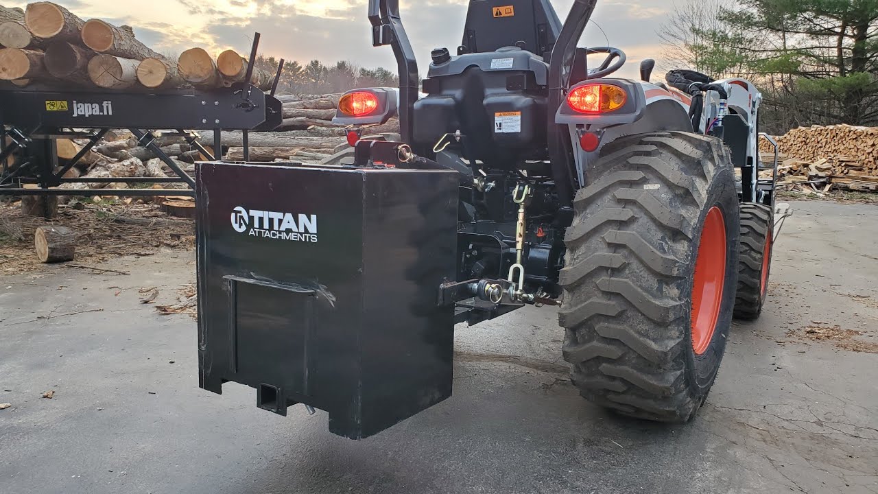 A Compact Tractor And A Box Of Rocks