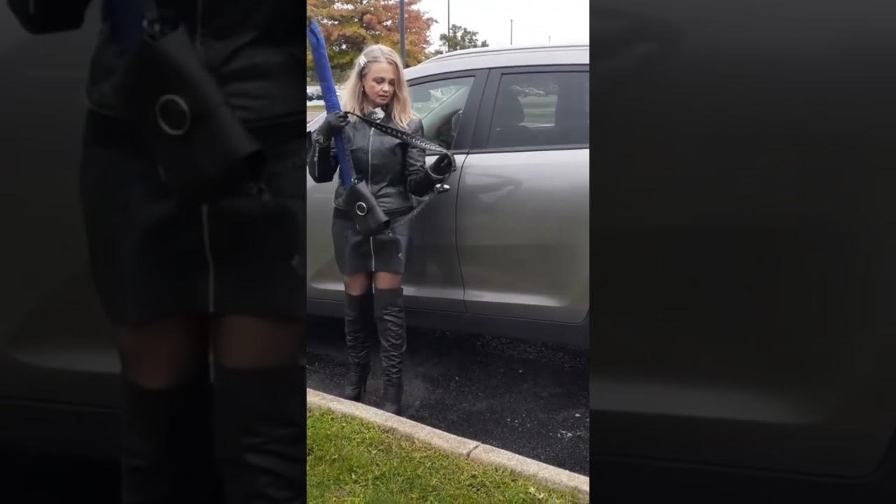Leather Queen arrived in style. Boots, skirt, jacket, gloves, umbrella