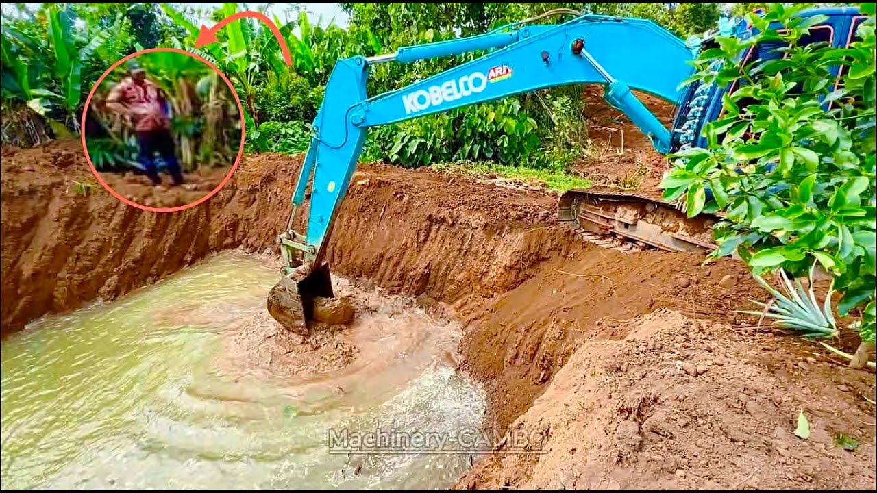 Excavator digs up soil to make a road to the site