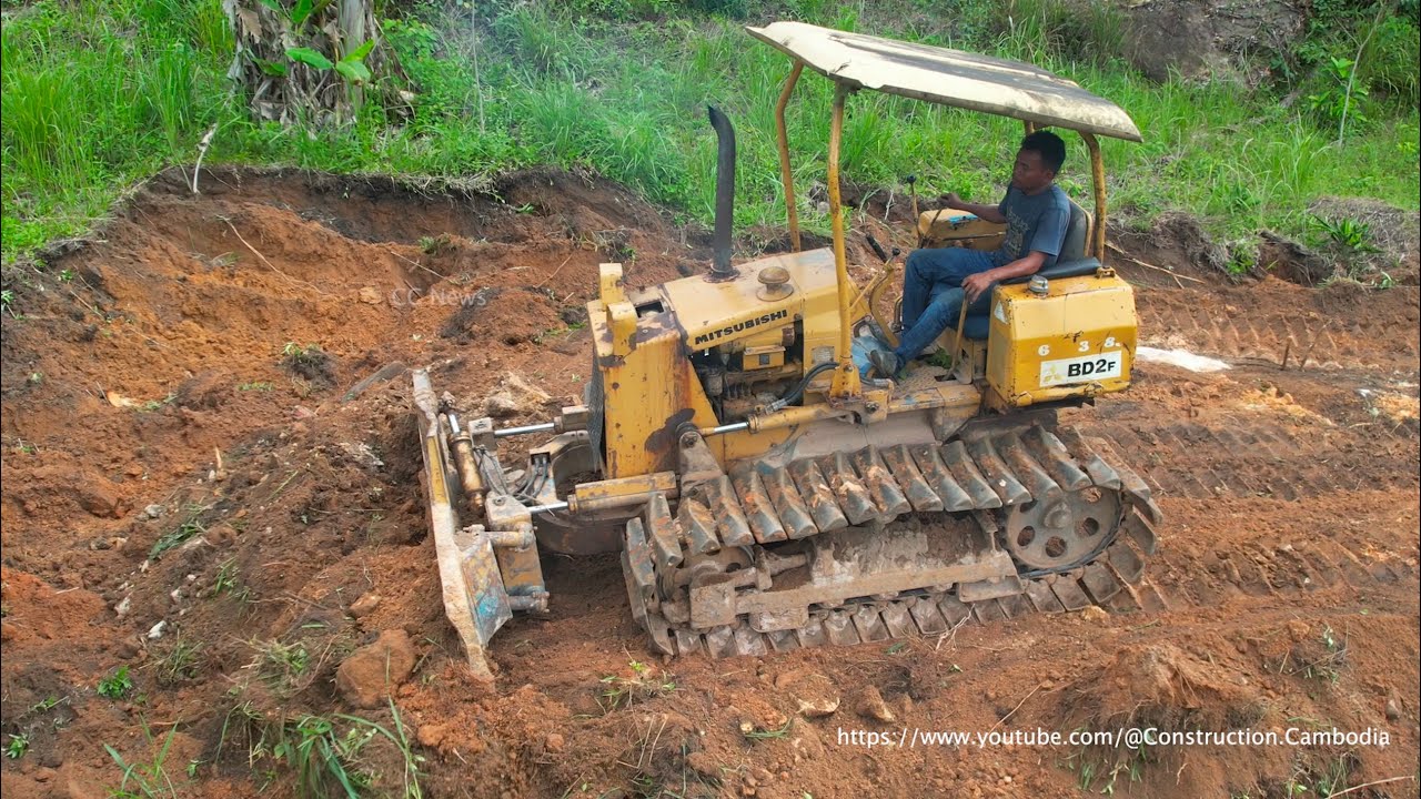 Strong Old Excavator And Bulldozer Leveling Ground For Plantation Road Construction On The Mountain
