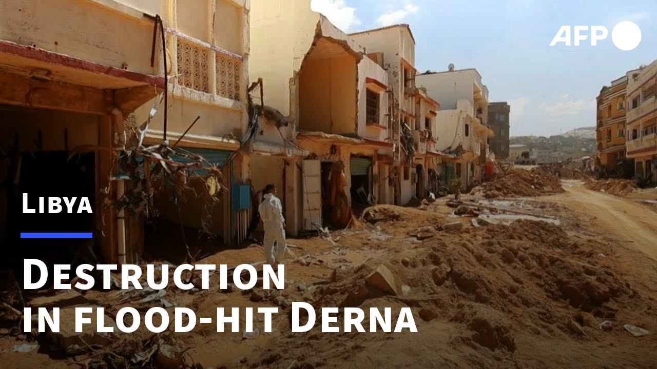 People walk amid rubble in Libya's flood-hit Derna | AFP